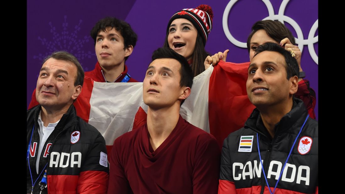 Canadian figure skater Patrick Chan, center front, reacts to his scores in the team competition.