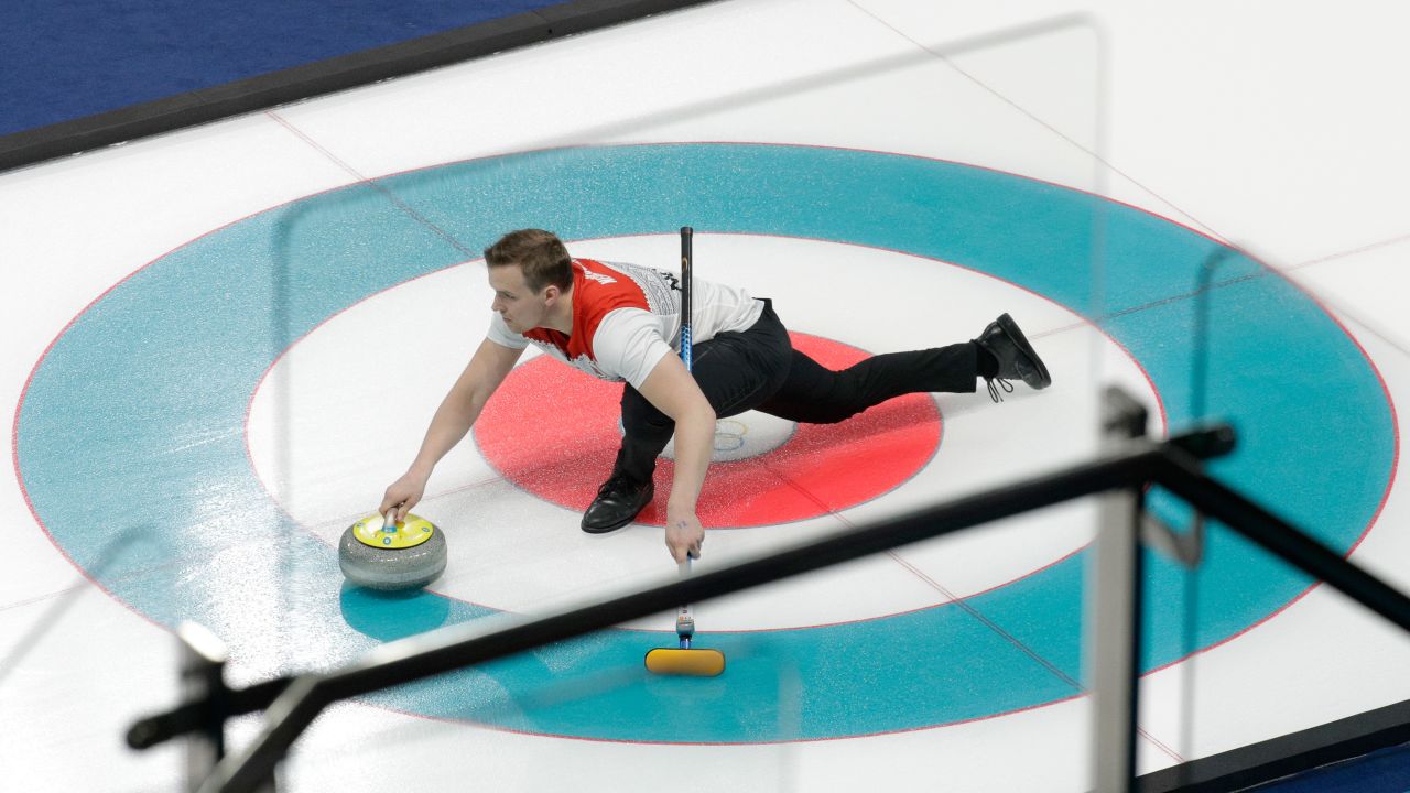 Norway's Magnus Nedregotten prepares to throw a stone during a mixed-doubles curling match.