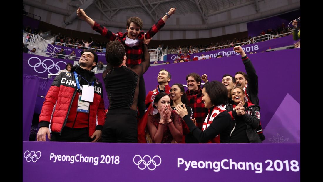 Ice dancers Scott Moir and Tessa Virtue wait for their score in the team figure-skating event. They played a key role in Canada winning the gold.