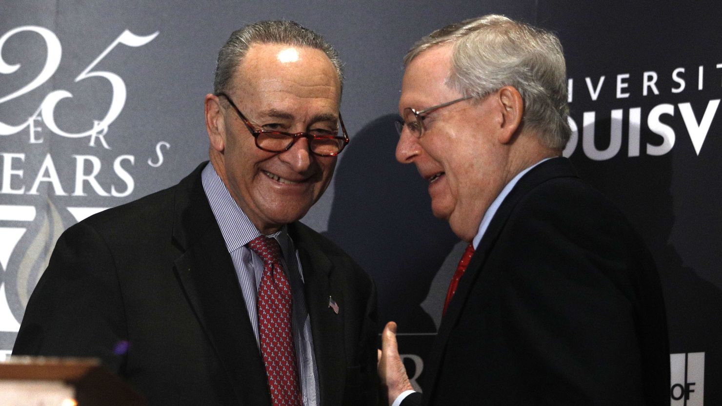Senate Majority Leader Mitch McConnell (right) and Senate Minority Leader Chuck Schumer (left) shake hands after Shumer delivered a speech in Louisville in February. (Bill Pugliano/Getty Images)