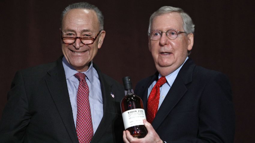 LOUISVILLE, KY - FEBRUARY 12: U.S. Senate Democratic Leader Chuck Schumer  (left) (D-NY), presents U.S. Senate Majority Leader Mitch McConnell (right) (R-KY) with a bottle of bourbon at the University of Louisville's McConnell Center where Schumer was scheduled to speak February 12, 2018 in Louisville, Kentucky. Sen. Schumer spoke at the event as part of the Center's Distinguished Speaker Series, and Sen. McConnell introduced him. (Bill Pugliano/Getty Images)