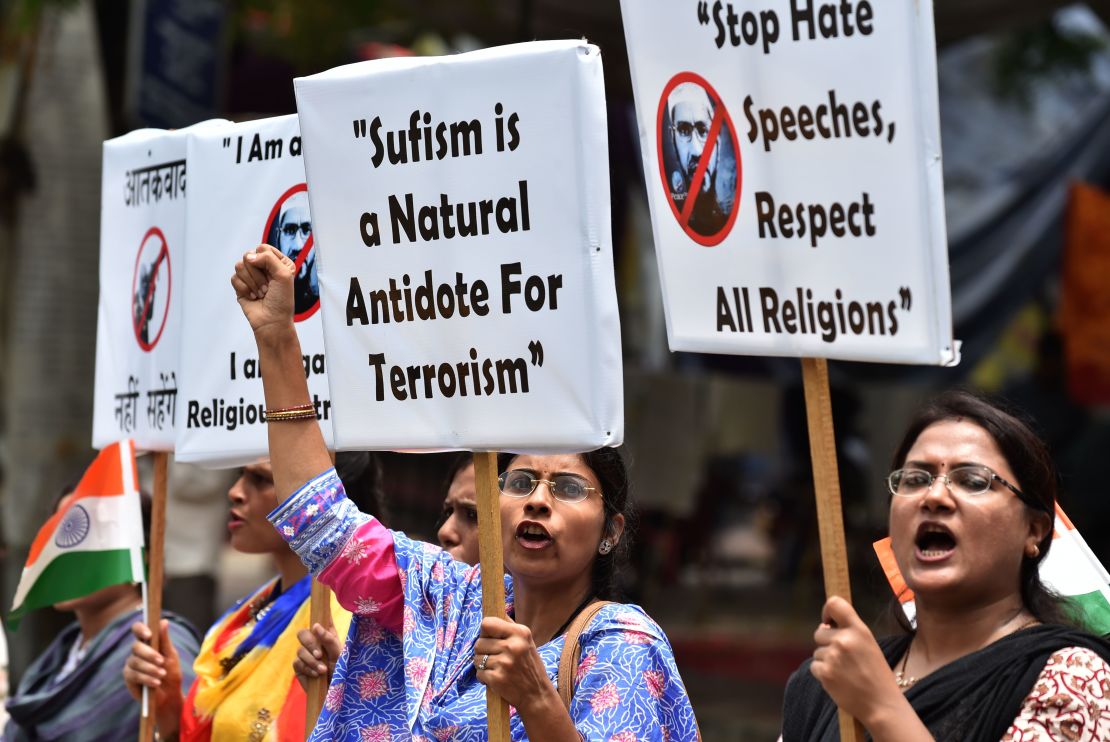 Indian protesters hold placards as they shout slogans during a protest denouncing Islamic scholar Zakir Naik in New Delhi on July 18, 2016.
