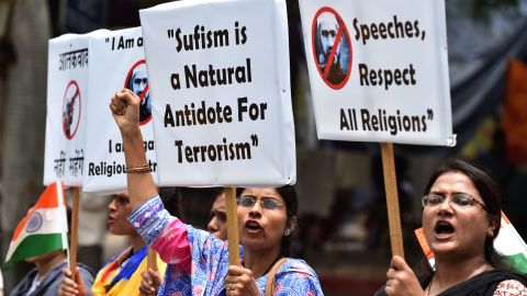 Indian protesters hold placards as they shout slogans during a protest denouncing Islamic scholar Zakir Naik in New Delhi on July 18, 2016.
