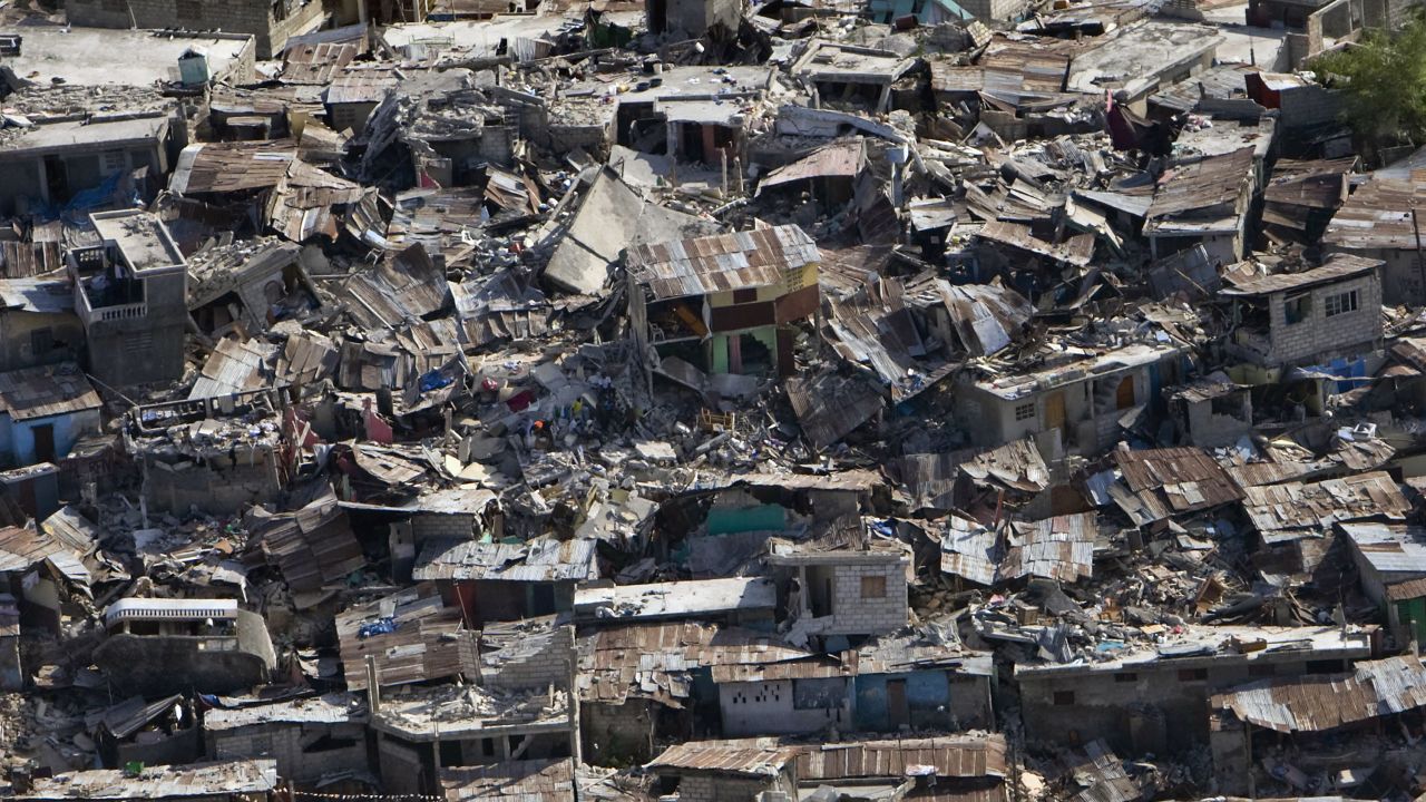 Houses in a poor neighborhood of Port-au-Prince lie in ruins a day after an  earthquake struck the Haitian capital on January 12, 2010.