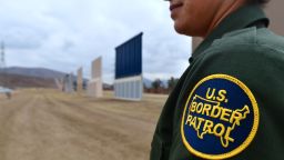 (FILES) In this file photo taken on November 1, 2017 US Border Patrol officer Tekae Michael stands near prototypes of US President Donald Trump's proposed border wall in San Diego, California. 
A border patrol agent whose mysterious death prompted President Donald Trump to renew his call for a wall along the US-Mexico border appears to have died as the result of an accident, according to an FBI probe. An FBI investigation into the November 2017 death of agent Rogelio Martinez has not found any evidence of foul play."To date none of the more than 650 interviews completed, locations searched, or evidence collected and analyzed have produced evidence that would support the existence of a scuffle, altercation, or attack," the FBI said in a statement on February 7, 2018.
 / AFP PHOTO / FREDERIC J. BROWNFREDERIC J. BROWN/AFP/Getty Images