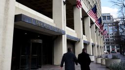 Pedestrians walk past the Federal Bureau of Investigation (FBI) headquarters in Washington, D.C., U.S., on Friday, Feb. 2, 2018. FBI and Justice Department officials got a warrant to spy on a Trump campaign associate by misleading a surveillance court judge, House Republicans contend in a newly released memo that Democrats have dismissed as a contrived account intended to protect the president. Photographer: T.J. Kirkpatrick/Bloomberg via Getty Images