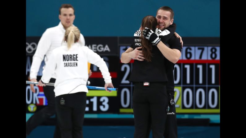 Anastasia Bryzgalova and Aleksandr Krushelnitckii, curling athletes from Russia, celebrate after defeating Norway for a bronze medal.