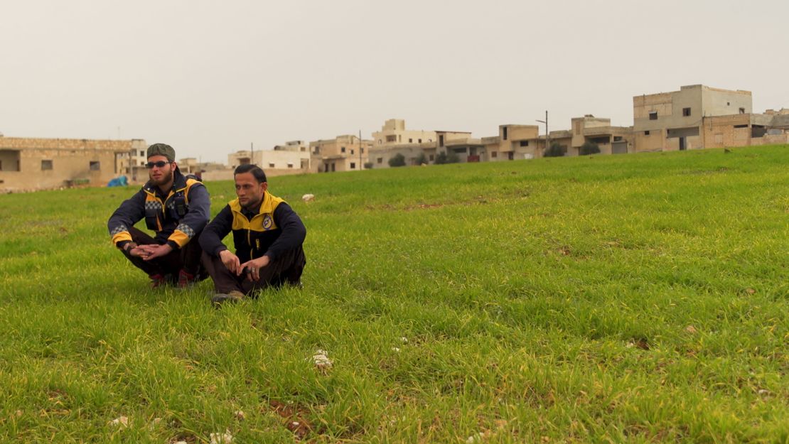 White Helmets volunteers Ayham Zeidan, 22, and Rami Dandal, 19, sit overlooking the scene of the attack in Saraqeb. Both were affected as they were trying to rescue other victims. 