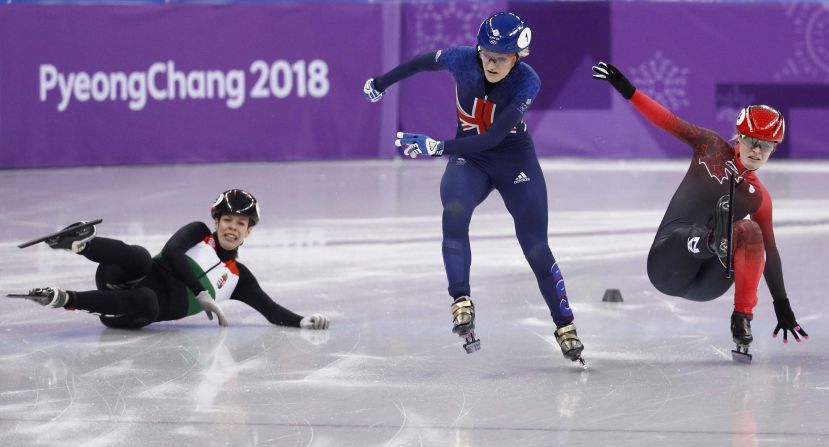 British speedskater Elise Christie, center, races past Hungary's Andrea Keszler, left, and Canada's Kim Boutin during a 500-meter short-track quarterfinal.