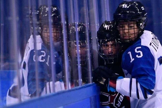 Finland's Minnamari Tuominen pins Canada's Jillian Saulnier against the glass during a preliminary-round hockey game. Canada, the gold medalists in each of the last four Olympics, won 4-1.