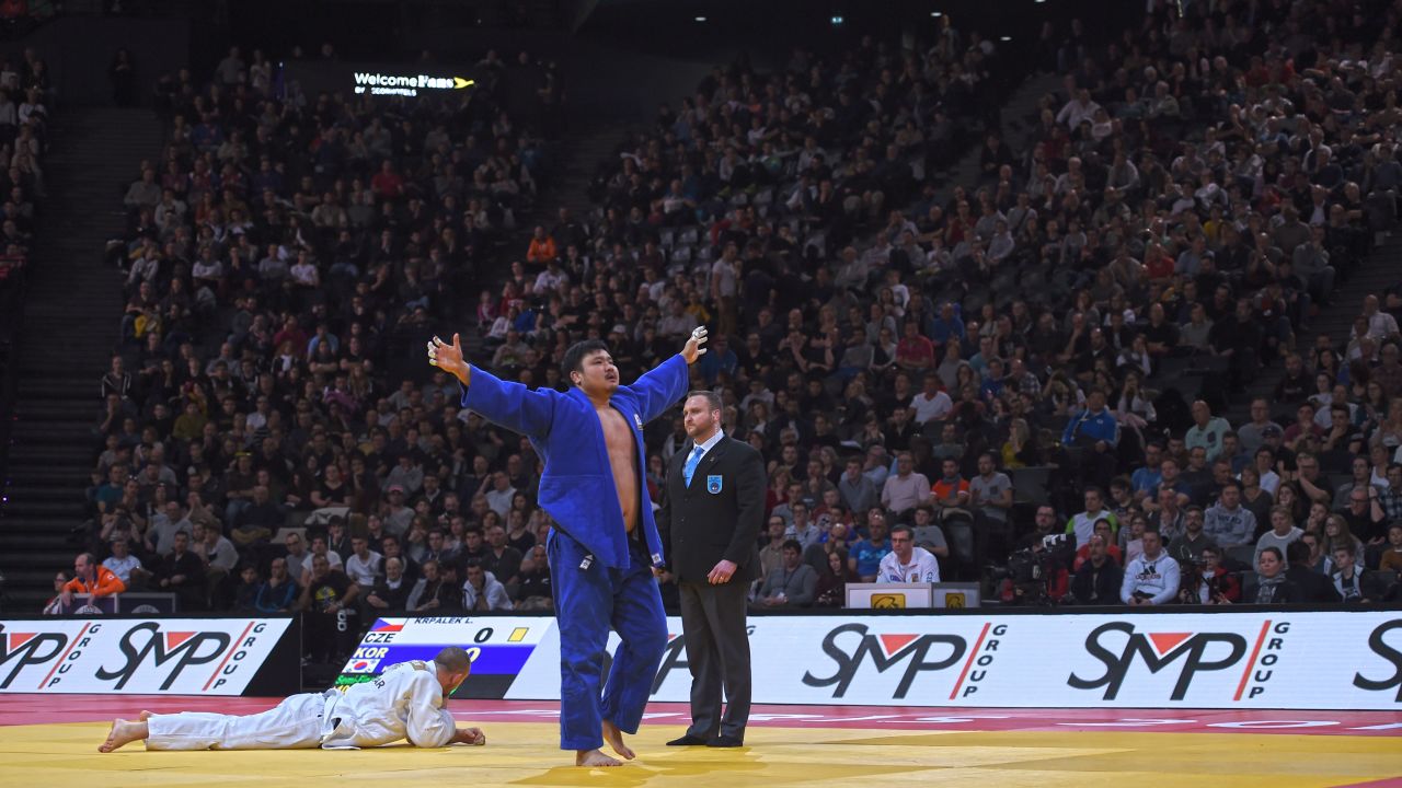 South Korea's Sungmin Kim celebrates defeating reigning half-heavyweight Olympic champion, Lukas Krpalek.