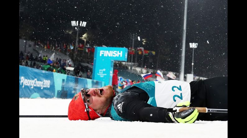 Germany's Thomas Bing lies on the snow after a cross-country skiing race.