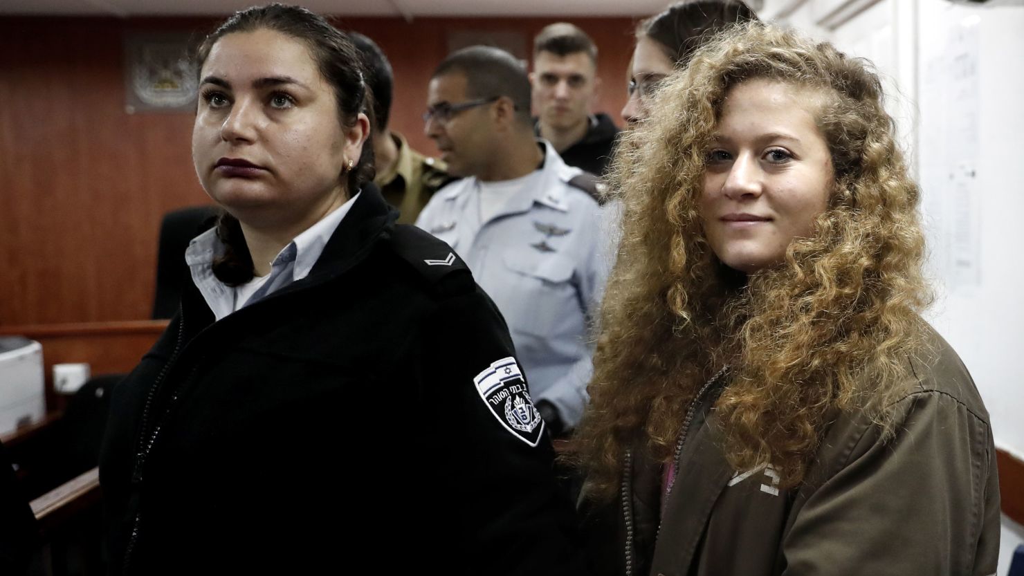 Ahed Tamimi (R) stands for the beginning of her trial on Tuesday. 