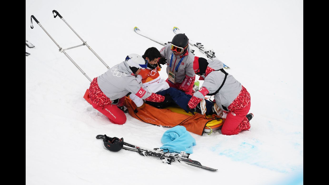 Medical staff attend to Japan's Yuto Totsuka after he crashed during the halfpipe final. He was taken to the hospital.