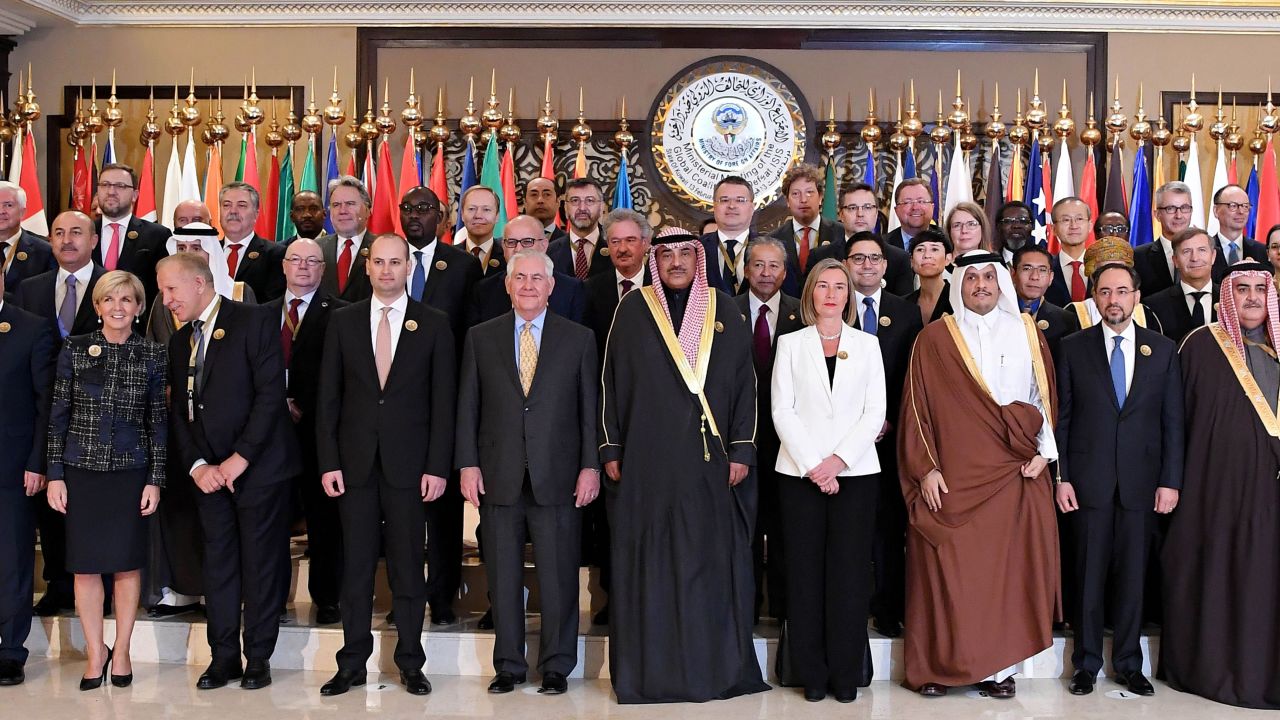 Kuwaiti Foreign Minister Sheikh Sabah al-Khaled al-Sabah, US Secretary of State Rex Tillerson, EU Foreign Policy Chief Frederica Mogherini, Qatari Foreign Minister Sheikh Mohammed bin Abdulrahman al-Thani, Afghan Foreign Minister Salahuddin Rabbani and Bahrain's Foreign Minister Sheikh Khalid bin Ahmed al-Khalifa pose with other officials for a group photo in Kuwait City.