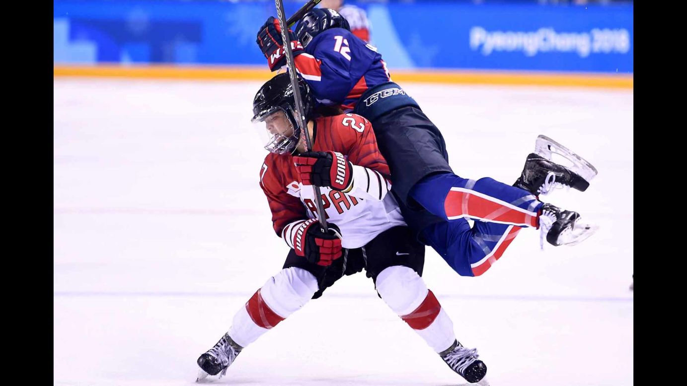 Korea's Kim Hee-won, right, collides with Japan's Shoko Ono during their preliminary-round hockey game.
