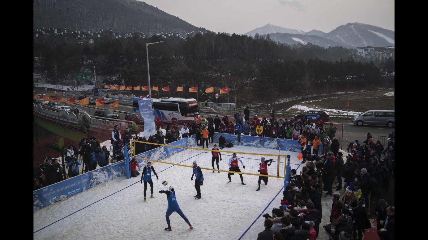 People watch a snow volleyball exhibition match at the Austria House in Pyeongchang.