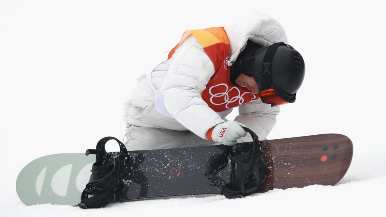 White takes off his snowboard after his last run. (Cameron Spencer/Getty Images)