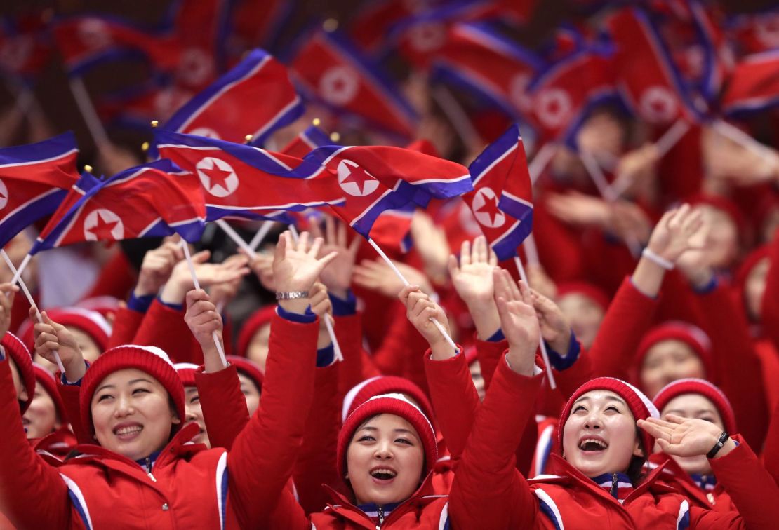 North Korean cheerleaders wave flags during the pair skating short program.