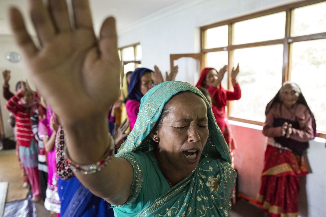 Nepalese Christians dance, sing and pray during a weekly church service in a small village of Tikhatal, in the Dolakha region of Nepal, 2017. 