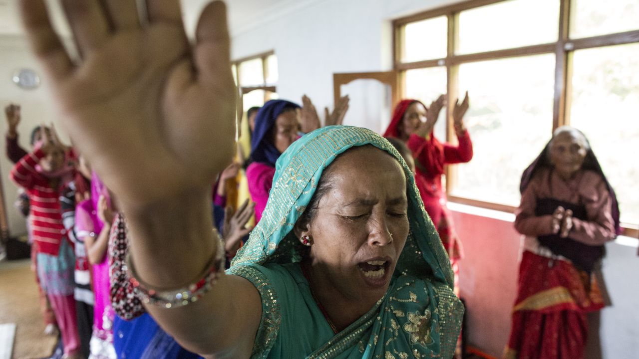 Nepalese Christians dance, sing and pray during a weekly church service in a small village of Tikhatal, in the Dolakha region of Nepal, 2017. 