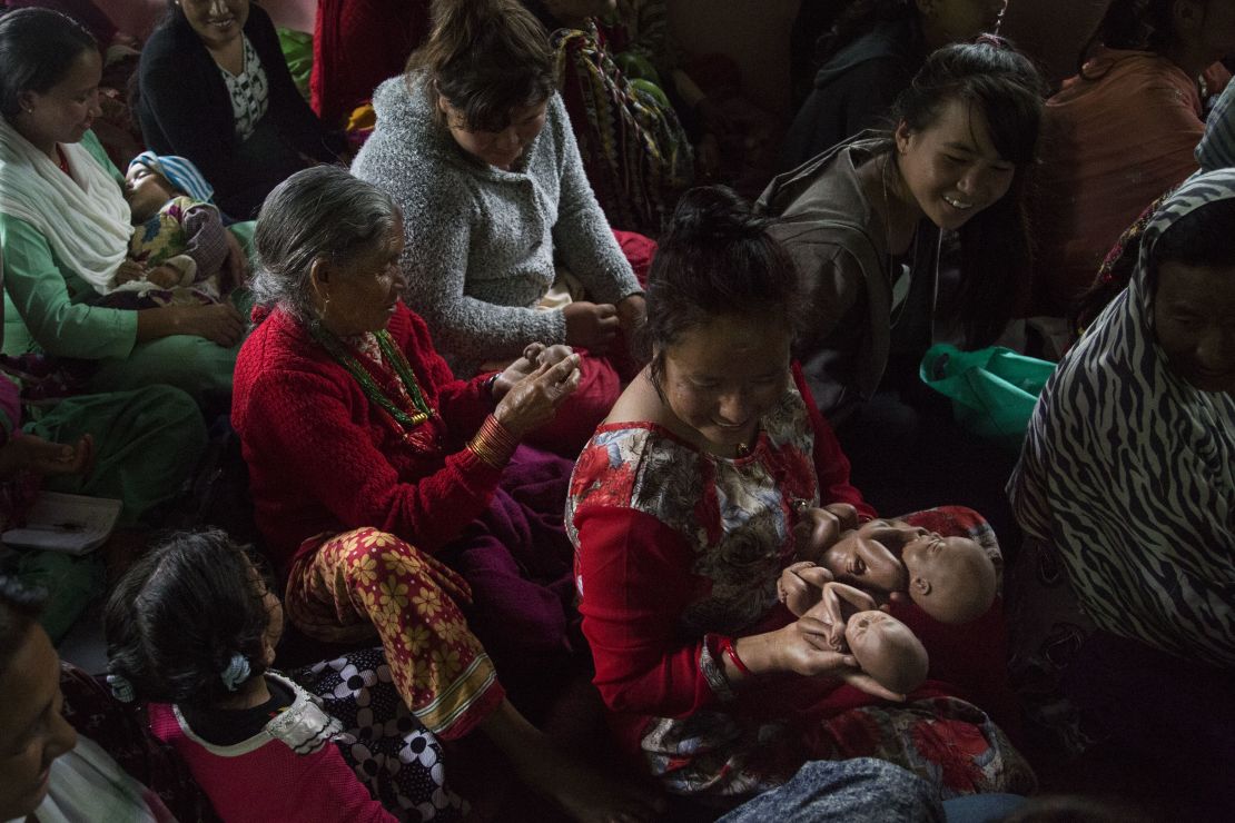 Church goers pass around fetal models, during a presentation by Rai. 
