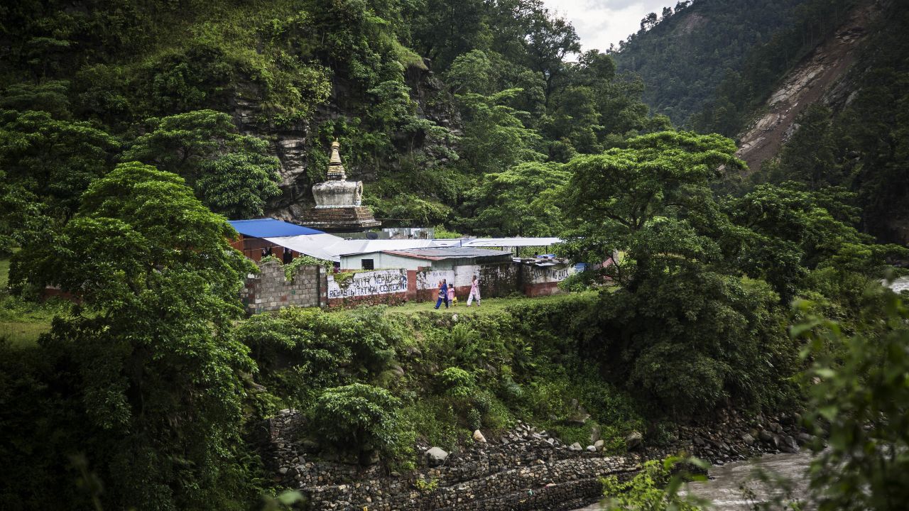 Nepalese Christians walk nearby a small Christian church and Hindu stupa after a lecture by Soman Rai, a pastor who founded the non-profit Voice of Fetus Nepal, in the village of Shilaprabat, Sindhupalcholk district, Nepal, 2017.