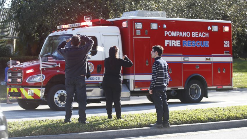 Anxious family members watch a rescue vehicle pass by, Wednesday, Feb. 14, 2018, in Parkland, Fla. A shooting at Marjory Stoneman Douglas High School school sent students rushing into the streets as SWAT team members swarmed in and locked down the building. (AP Photo/Wilfredo Lee)