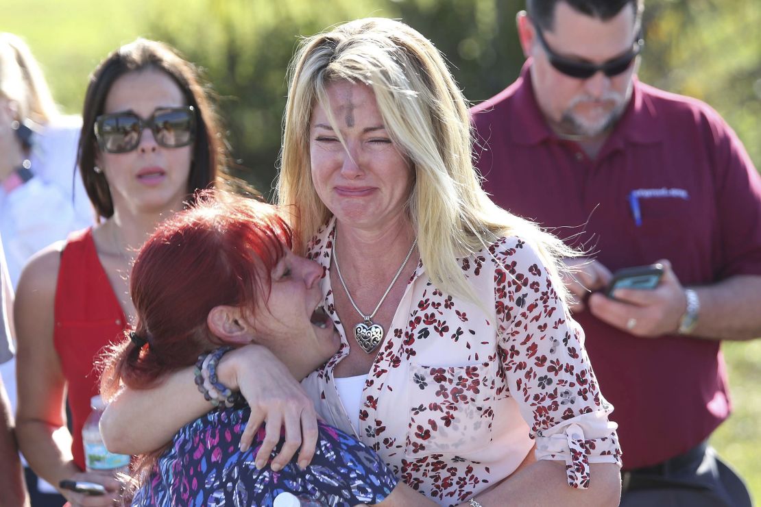 Parents wait for news after reports of the shooting at Marjory Stoneman Douglas High School.