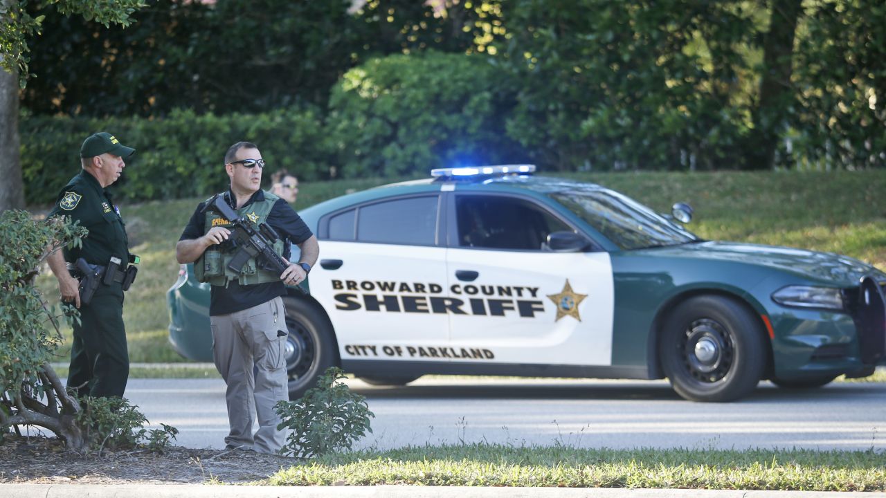 Law enforcement officers block off a street following a shooting at Marjory Stoneman Douglas High School, Wednesday, Feb. 14, 2018, in Parkland, Fla. (AP Photo/Wilfredo Lee)