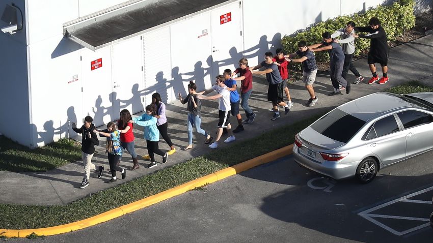 PARKLAND, FL - FEBRUARY 14:  People are brought out of the Marjory Stoneman Douglas High School after a shooting at the school that reportedly killed and injured multiple people on February 14, 2018 in Parkland, Florida. Numerous law enforcement officials continue to investigate the scene.  (Photo by Joe Raedle/Getty Images)