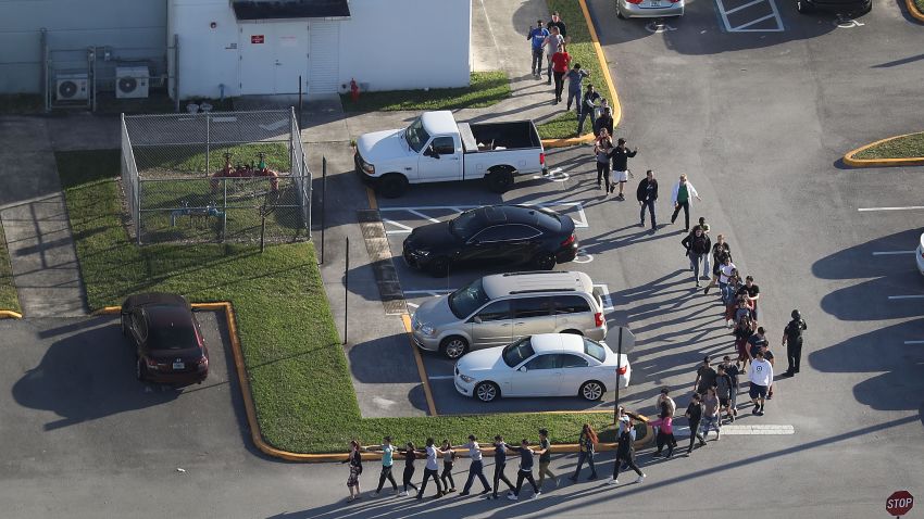PARKLAND, FL - FEBRUARY 14:  People are brought out of the Marjory Stoneman Douglas High School after a shooting at the school that reportedly killed and injured multiple people on February 14, 2018 in Parkland, Florida. Numerous law enforcement officials continue to investigate the scene.  (Photo by Joe Raedle/Getty Images)