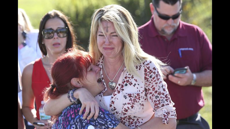 Parents wait for news after a shooting at Marjory Stoneman Douglas High School in Parkland, Florida, on Wednesday, February 14.<a href="index.php?page=&url=https%3A%2F%2Fwww.cnn.com%2F2018%2F02%2F14%2Fus%2Fflorida-high-school-shooting%2Findex.html" target="_blank"> At least 17 people were killed at the school</a>,  Broward County Sheriff Scott Israel said. The suspect, 19-year-old former student Nikolas Cruz, is in custody, the sheriff said. The sheriff said he was expelled for unspecified disciplinary reasons.