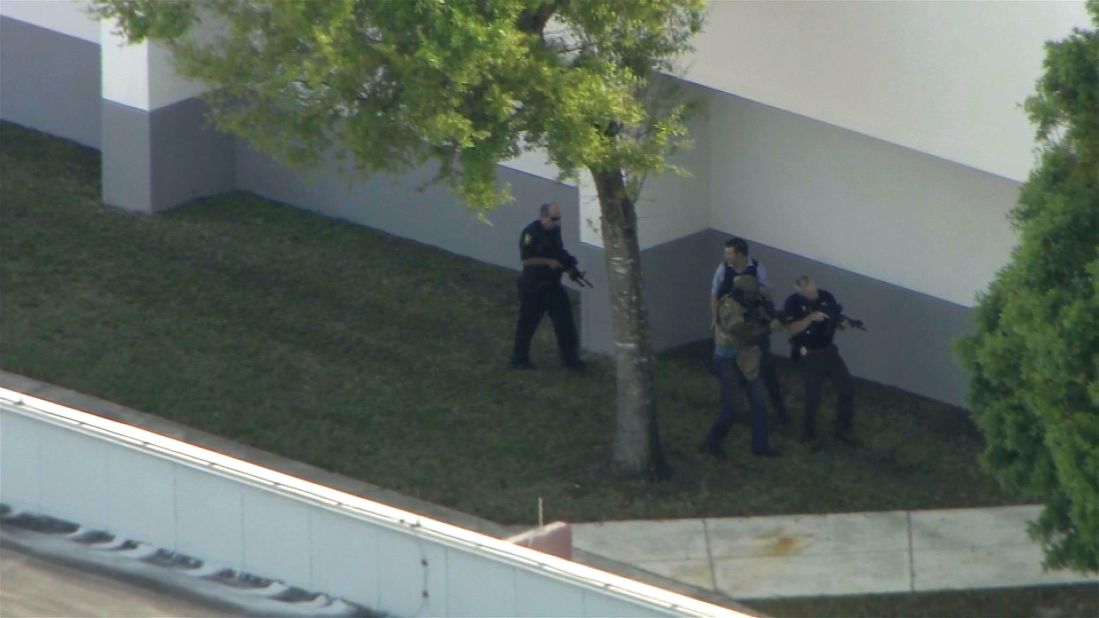Police officers surveil the exterior of the school while the shooting was active.