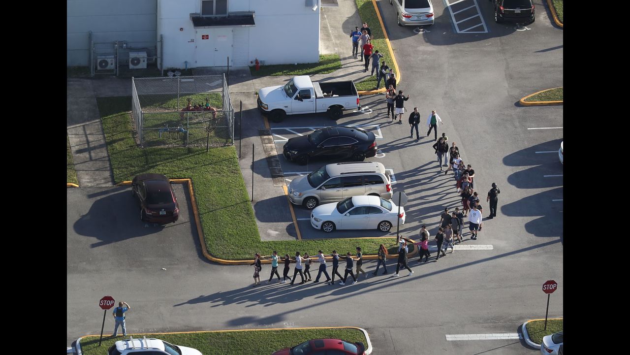 PARKLAND, FL - FEBRUARY 14:  People are brought out of the Marjory Stoneman Douglas High School after a shooting at the school that reportedly killed and injured multiple people on February 14, 2018 in Parkland, Florida. Numerous law enforcement officials continue to investigate the scene.  (Photo by Joe Raedle/Getty Images)