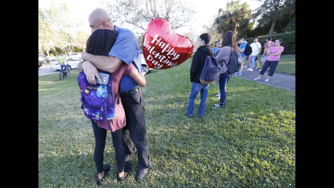 Family members embrace after shooting.