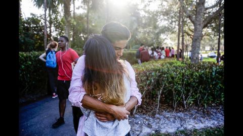 Lavinia Zapata embraces her son, Jorge, after he was evacuated from the school.