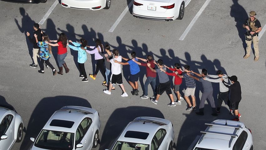 PARKLAND, FL - FEBRUARY 14:  People are brought out of the Marjory Stoneman Douglas High School after a shooting at the school that reportedly killed and injured multiple people on February 14, 2018 in Parkland, Florida. Numerous law enforcement officials continue to investigate the scene.  (Photo by Joe Raedle/Getty Images)