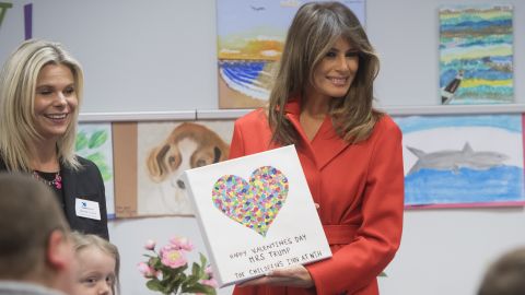 First lady Melania Trump holds up a gift as she exchanges valentines for Valentine's Day as she visits with children who are currently patients at the National Institutes of Health (NIH) at The Children's Inn at NIH in Bethesda, Maryland. 