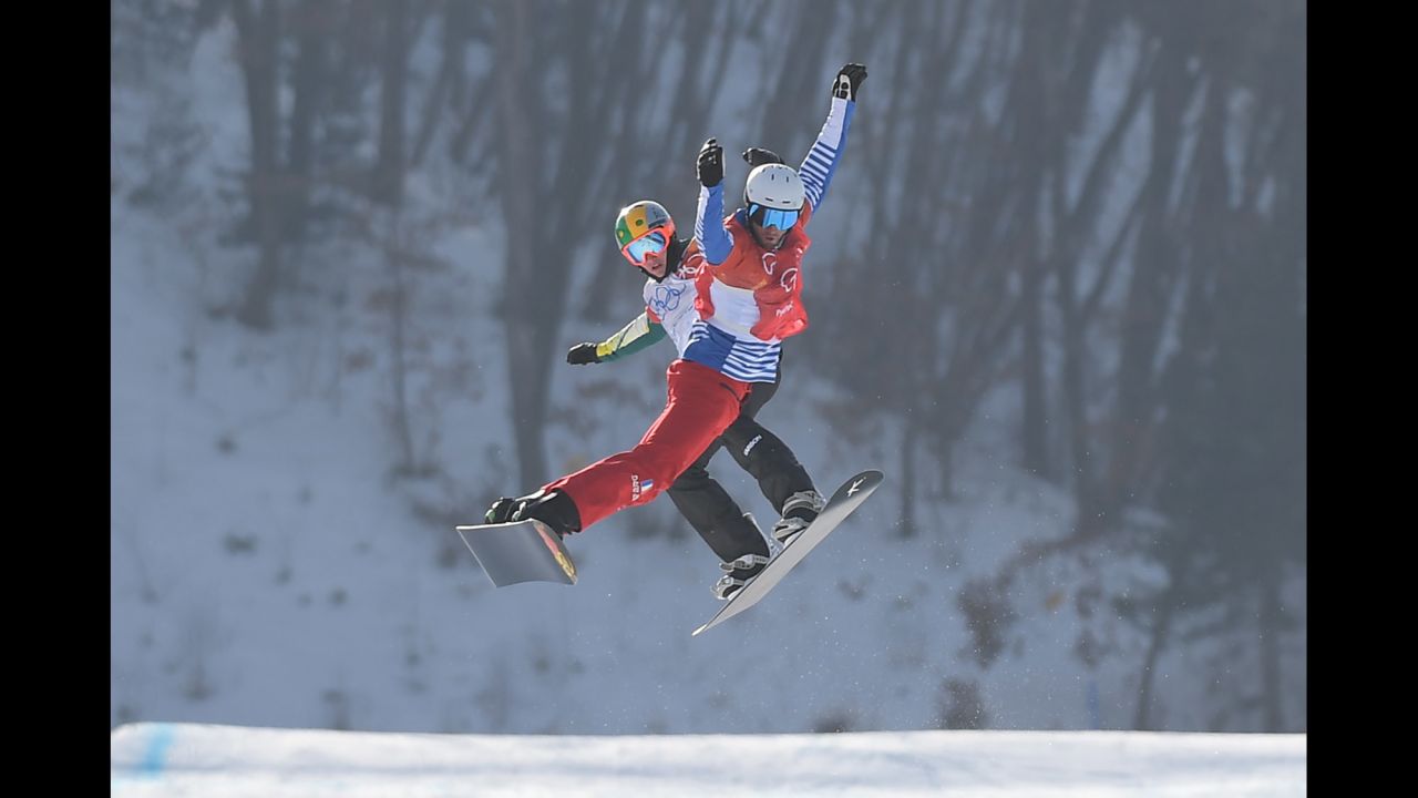 France's Pierre Vaultier, front, leads Australia's Jarryd Hughes during the final of snowboard cross. Vaultier won gold for the second straight Olympics.