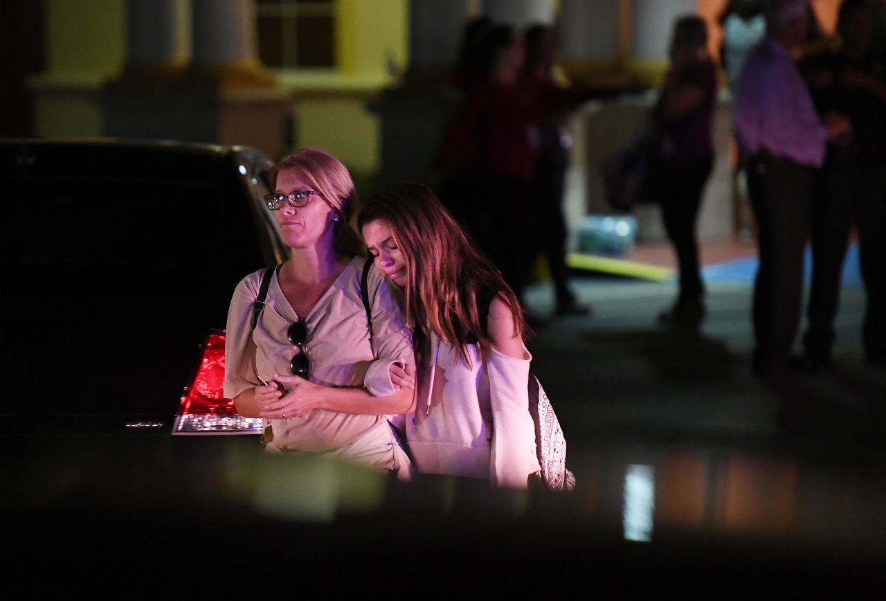 People embrace while leaving the Fort Lauderdale Marriott Coral Springs Hotel, which authorities designated as a staging point for witnesses to the shooting.