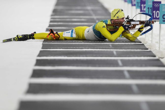 Sweden's Fredrik Lindstrom fires his rifle during the 20-kilometer biathlon.