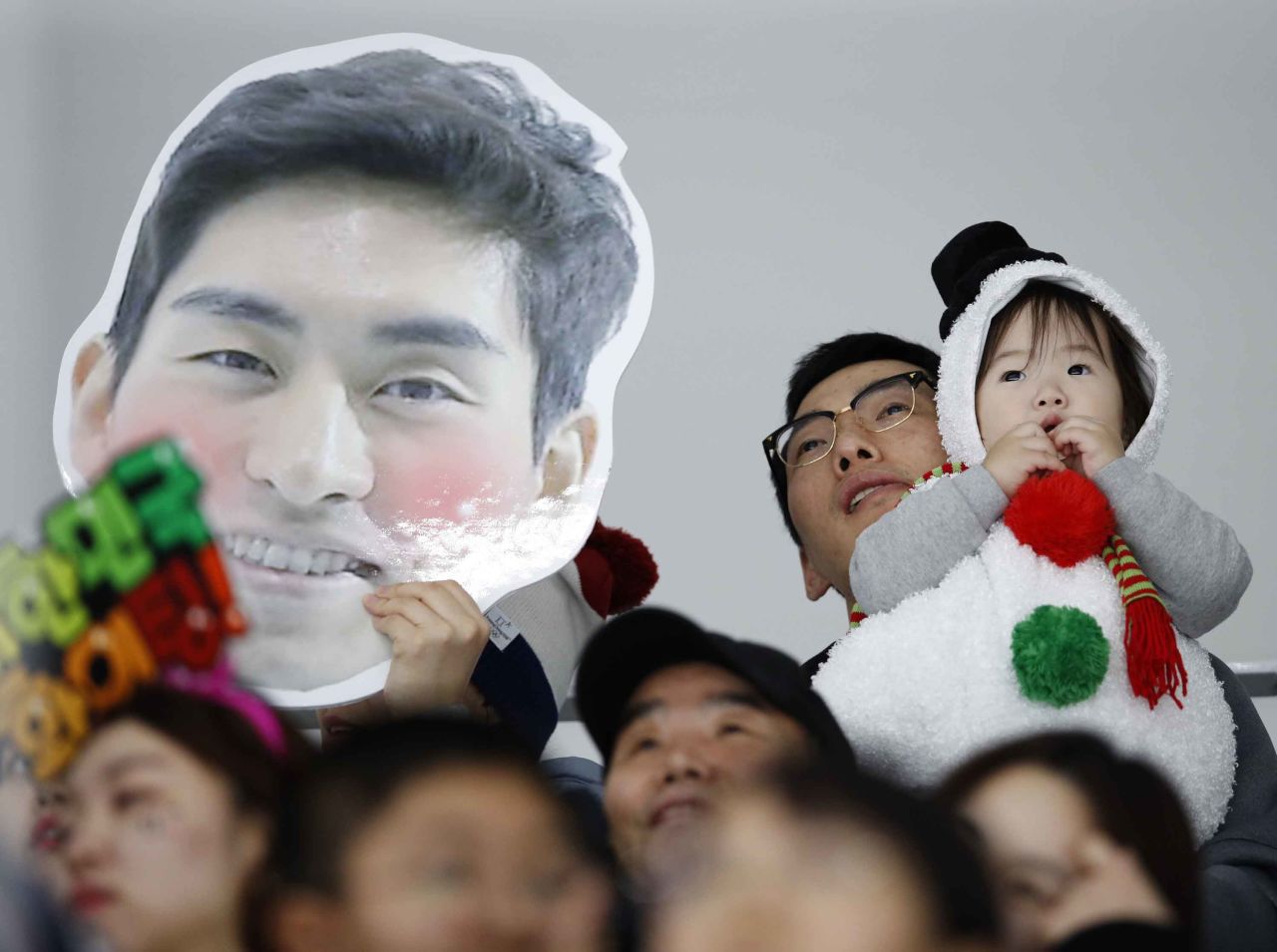 A spectator holds a picture of South Korean speedskater Lee Seung-hoon during the 10,000 meters.