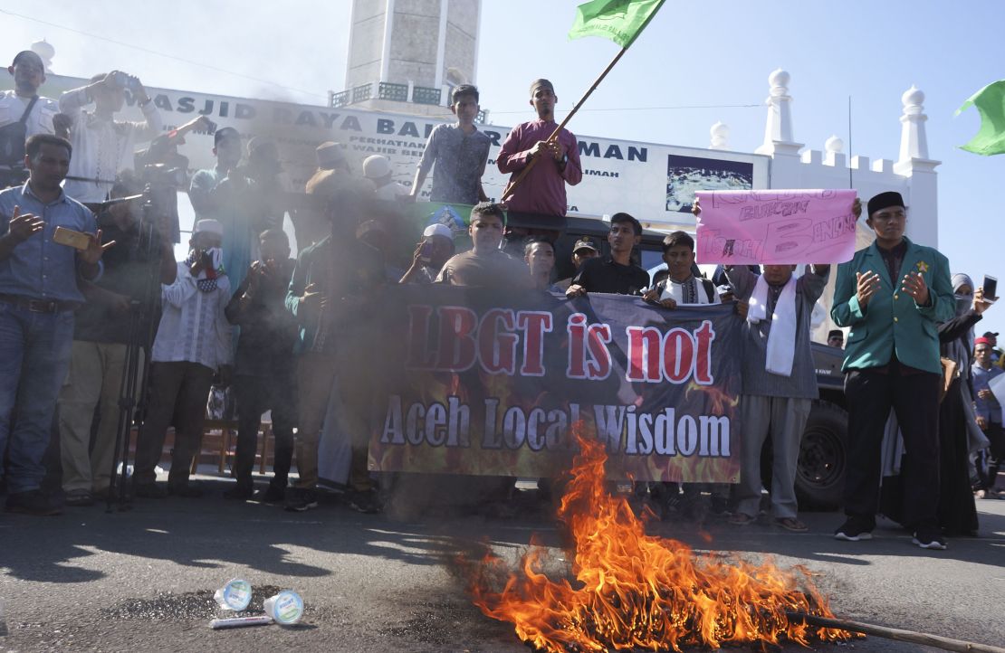 Muslim protesters pray as they burn an effigy during an anti-LGBT rally in Banda Aceh, Friday, February 2.