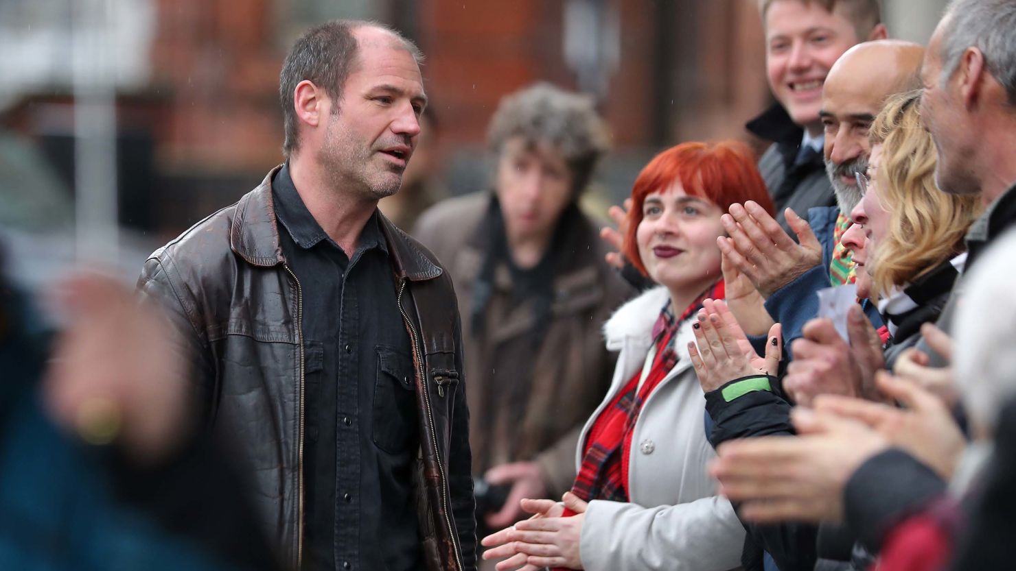 James Matthews, 43, was met by supporters as he arrived at a London court Wednesday. 