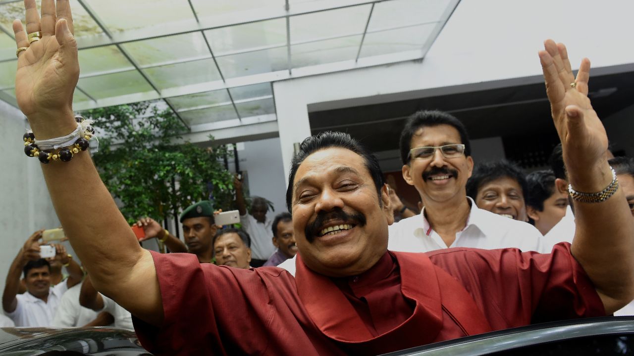 Former Sri Lankan president Mahinda Rajapakse waves to supporters at the party office following a press conference after winning the local government election in the capital Colombo on February 12, 2018.
