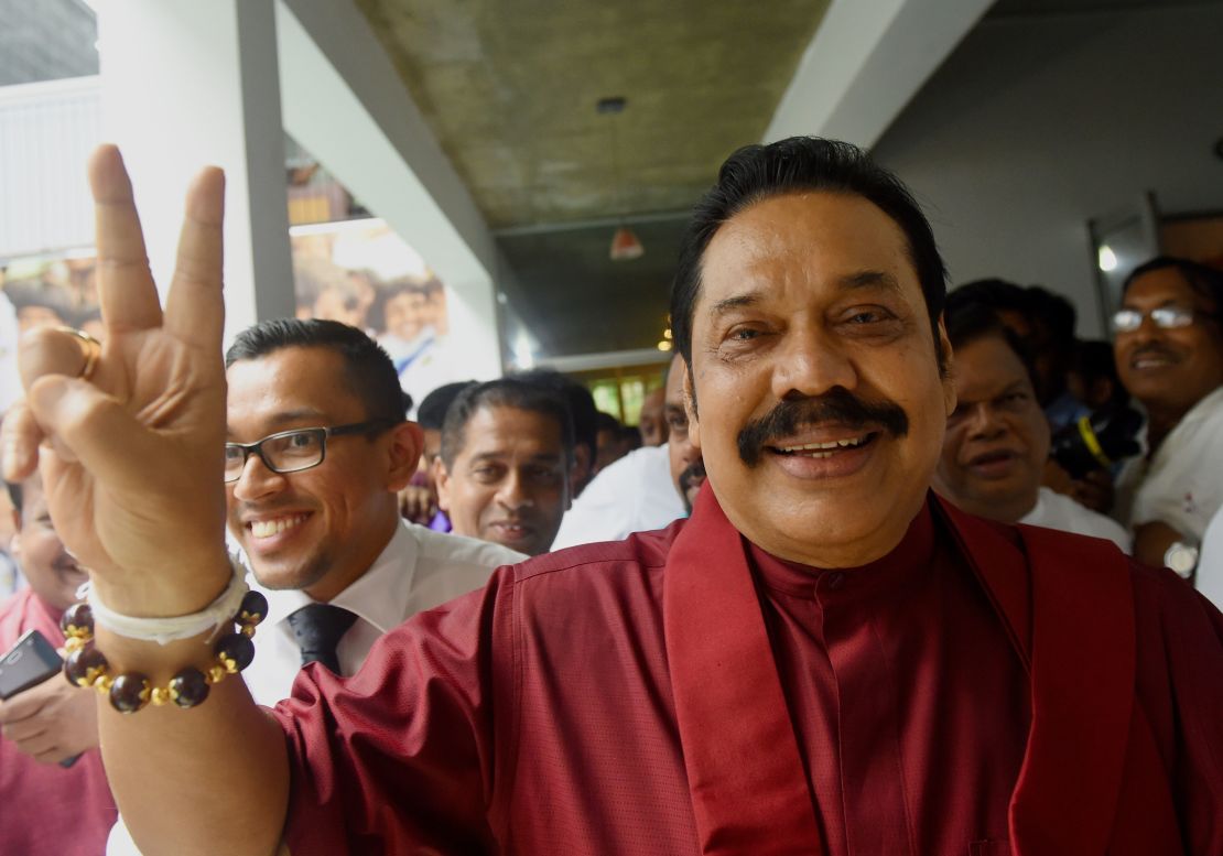 Former Sri Lankan president Mahinda Rajapakse waves to supporters at the party office following a press conference after winning the local government election in the capital Colombo on February 12, 2018.
