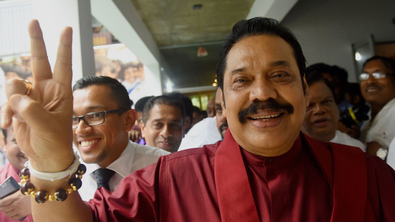 Former Sri Lankan president Mahinda Rajapakse waves to supporters at the party office following a press conference after winning the local government election in the capital Colombo on February 12, 2018.