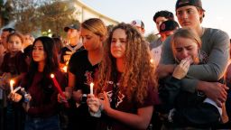 Mourners react during a candlelight vigil for the victims of Marjory Stoneman Douglas High School shooting in Parkland, Florida on February 15, 2018.A former student, Nikolas Cruz, opened fire at the Florida high school leaving 17 people dead and 15 injured. / AFP PHOTO / RHONA WISE        (Photo credit should read RHONA WISE/AFP/Getty Images)