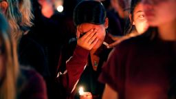 A woman cries during a candlelight vigil for the victims of the Wednesday shooting at Marjory Stoneman Douglas High School, in Parkland, Fla., Thursday, Feb. 15, 2018. Nikolas Cruz, a former student, was charged with 17 counts of premeditated murder on Thursday. (AP Photo/Gerald Herbert)